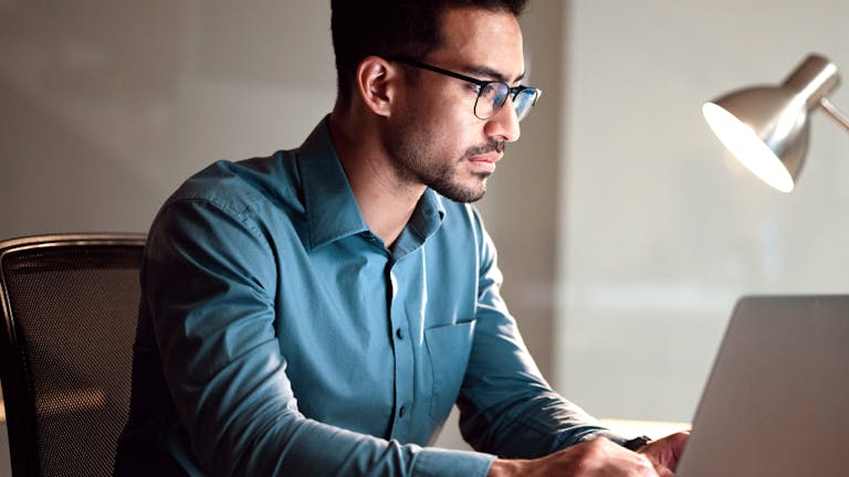 Working adult looking at laptop screen