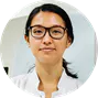 circular image of a woman wearing glasses looking at the camera