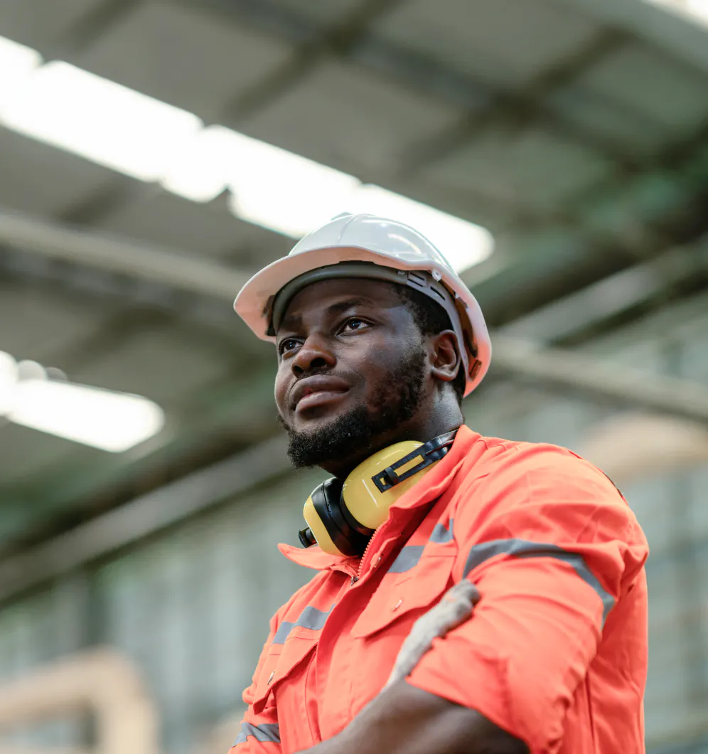 Man in a PPE working in a manufacturing plant.