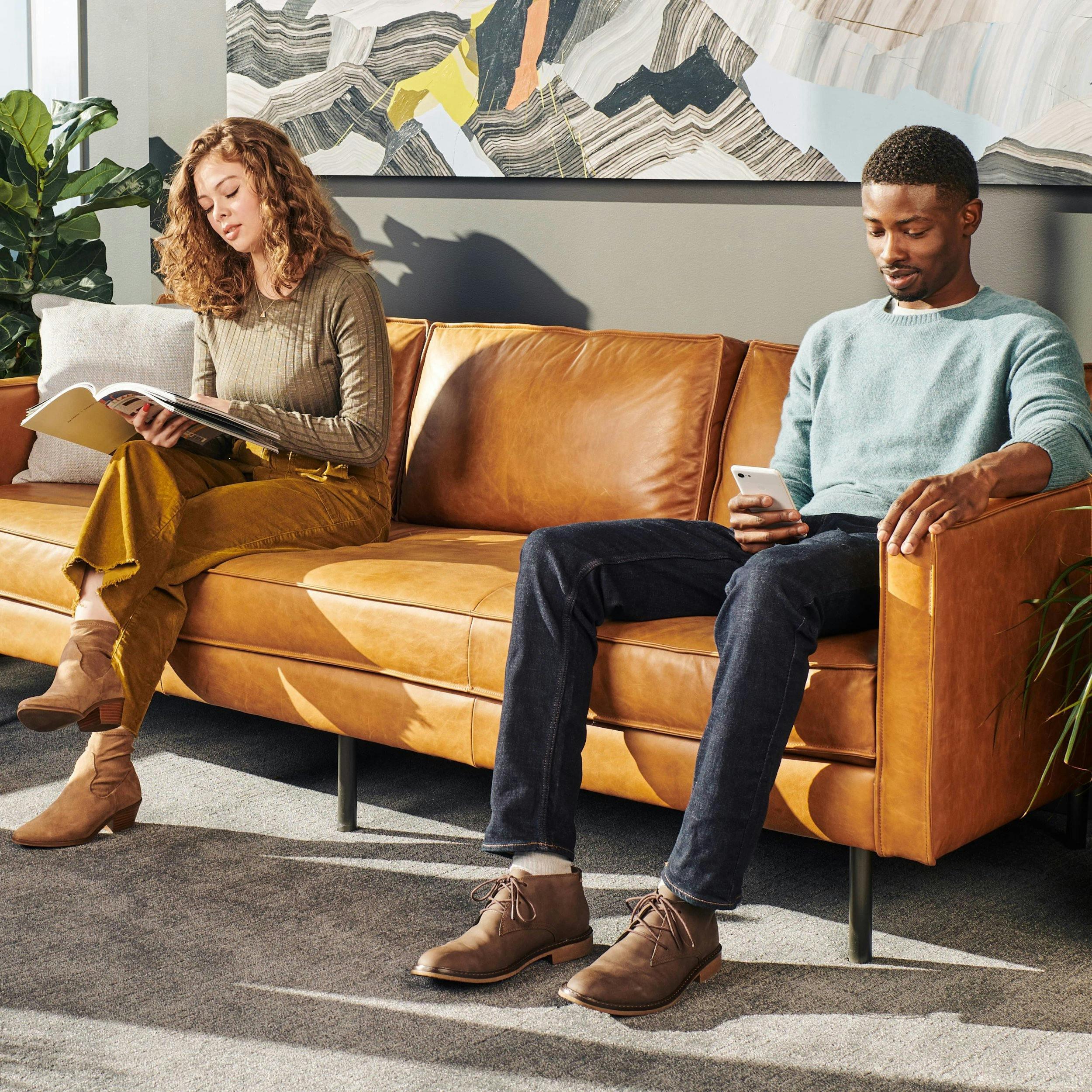 A man and women sit in a doctor's office waiting room.