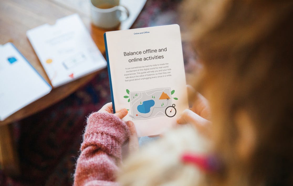 A mother holds one of the cards title, "Online and Offline" and reads about how she can balance offline and online activities.