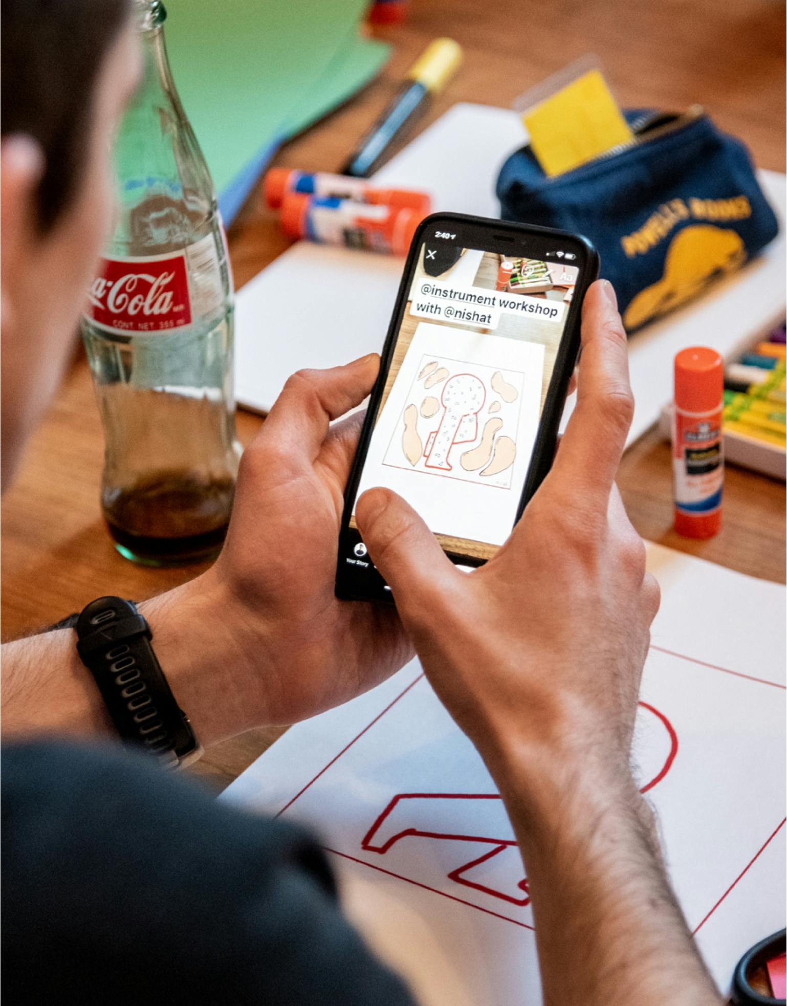 Instrument team member interacting with a mobile device regarding an upcoming workshop