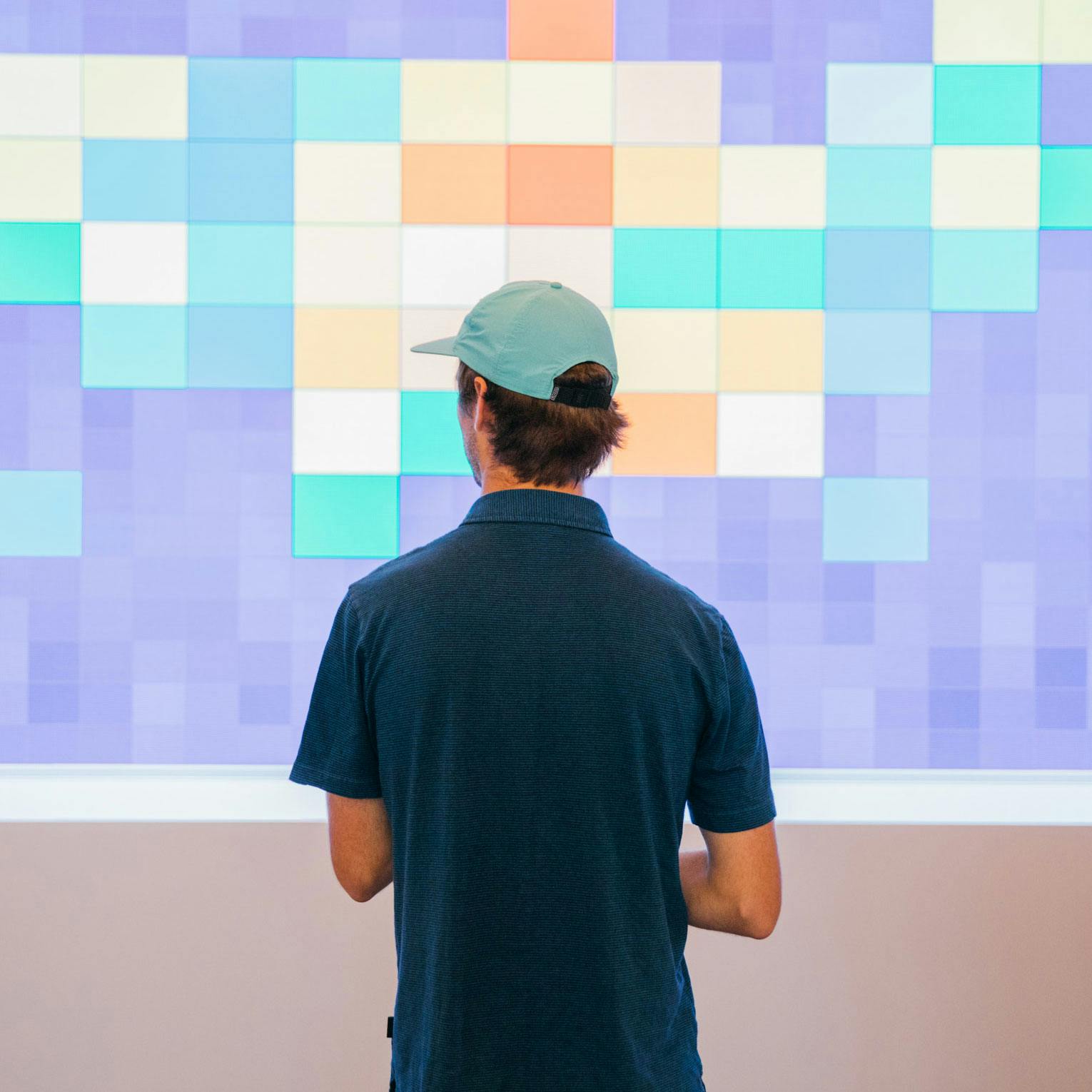 A man stands in front of the the projected Google Sheet animations.