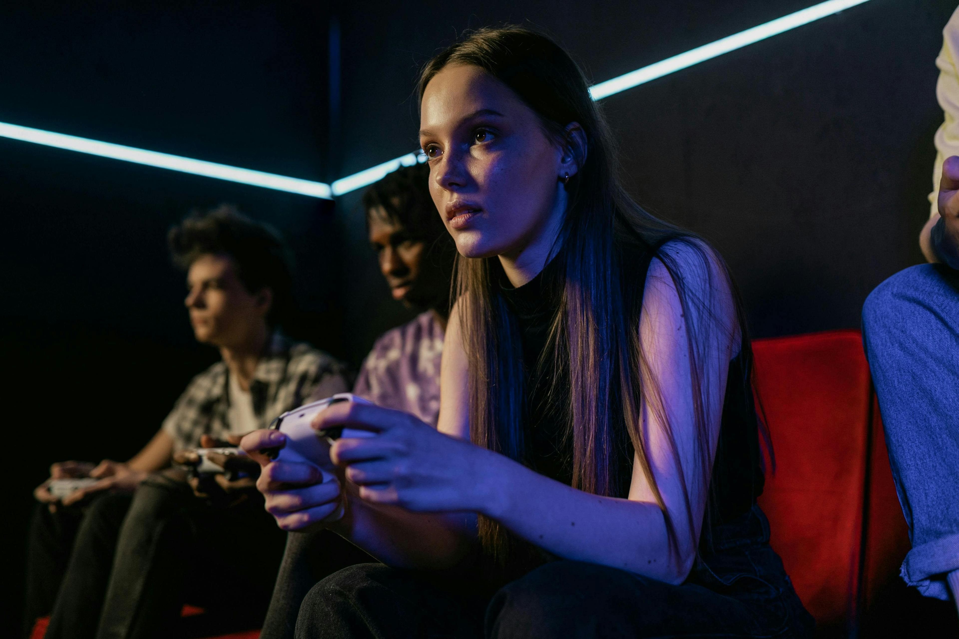 Young person holding a controller playing video games