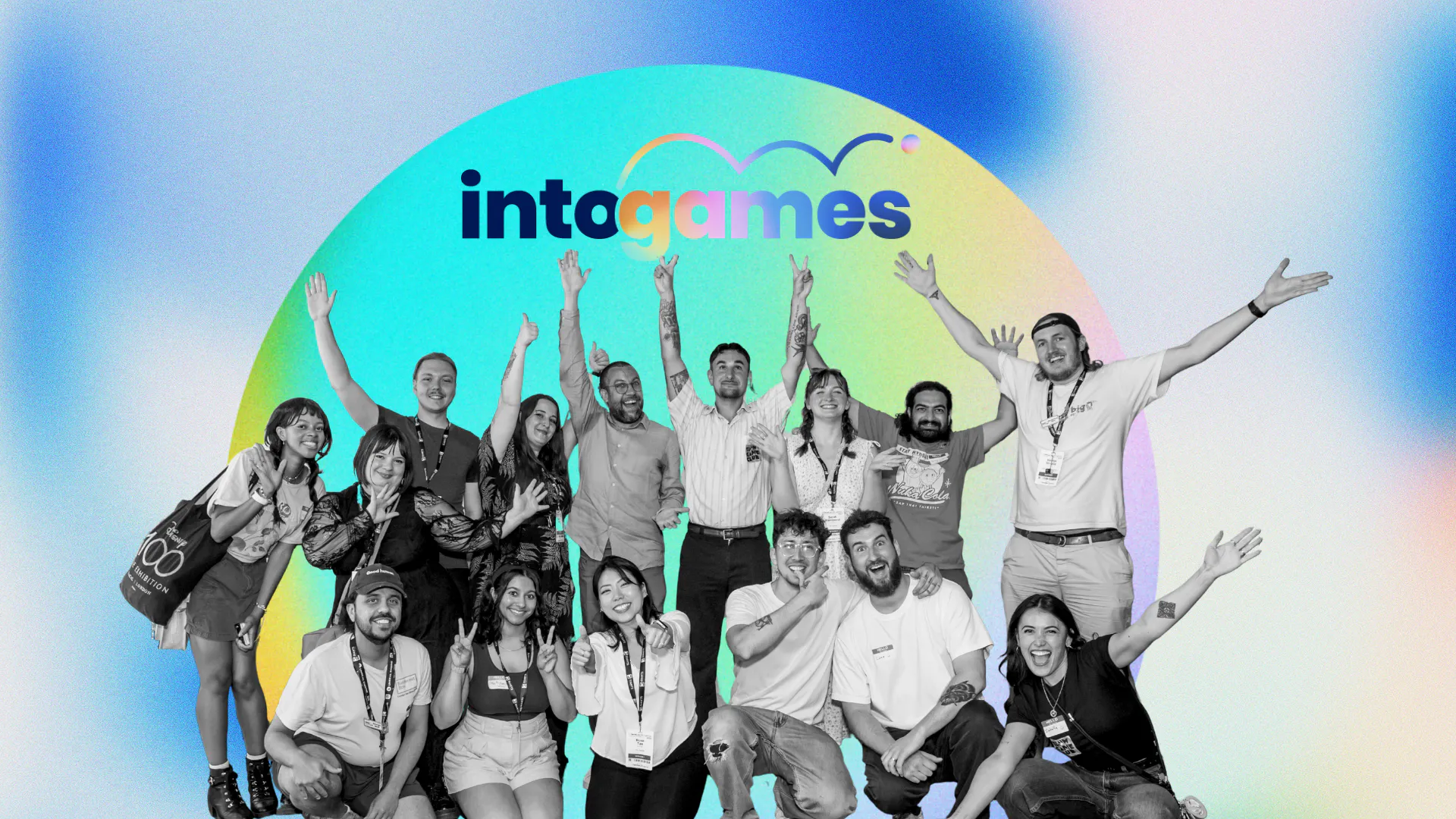 In front of a blue background, Photo of the Into Games Team smiling at the camera, arms up in the air.