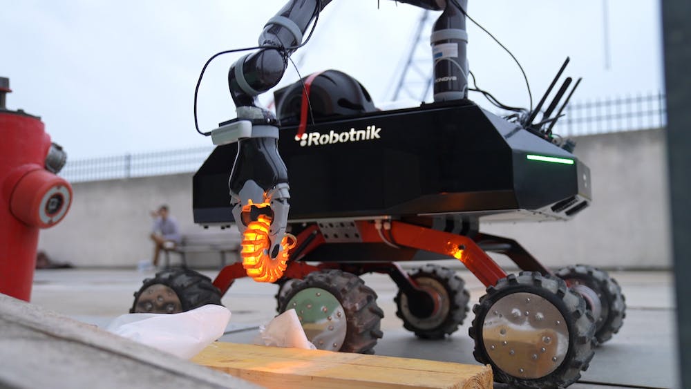 The robot arm picking up an object.