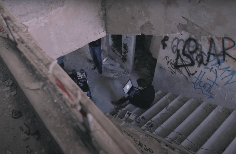 a stair in an abandonned hospital, with the UGV and a technical partner