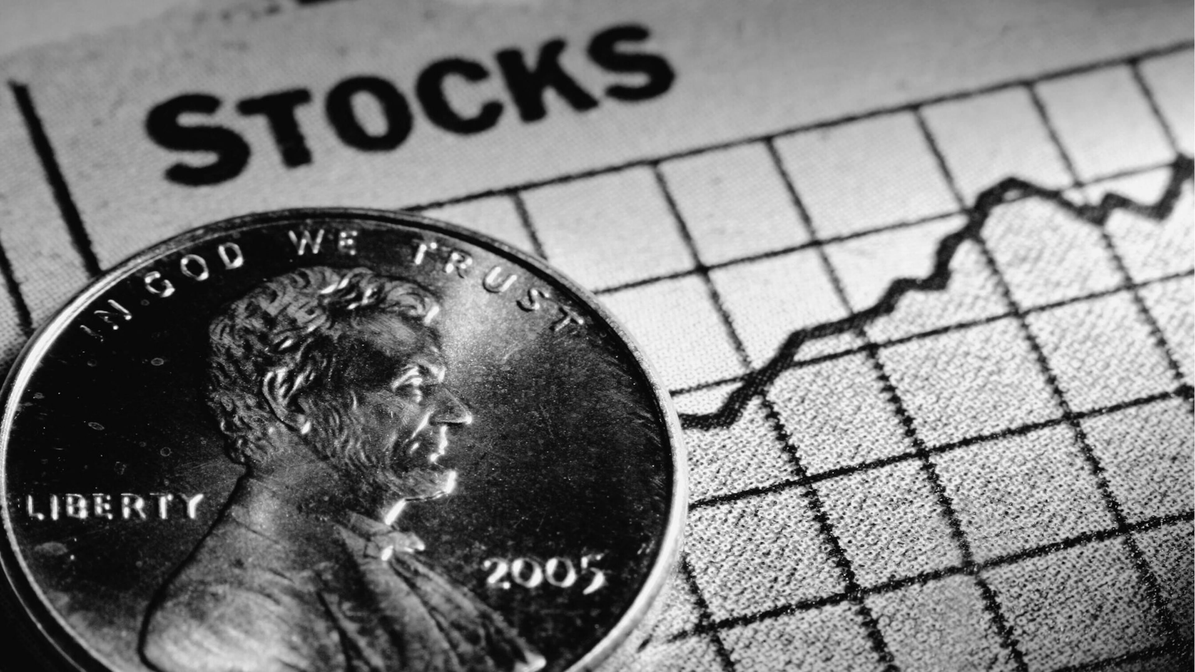image depicting a coin placed on a stock chart