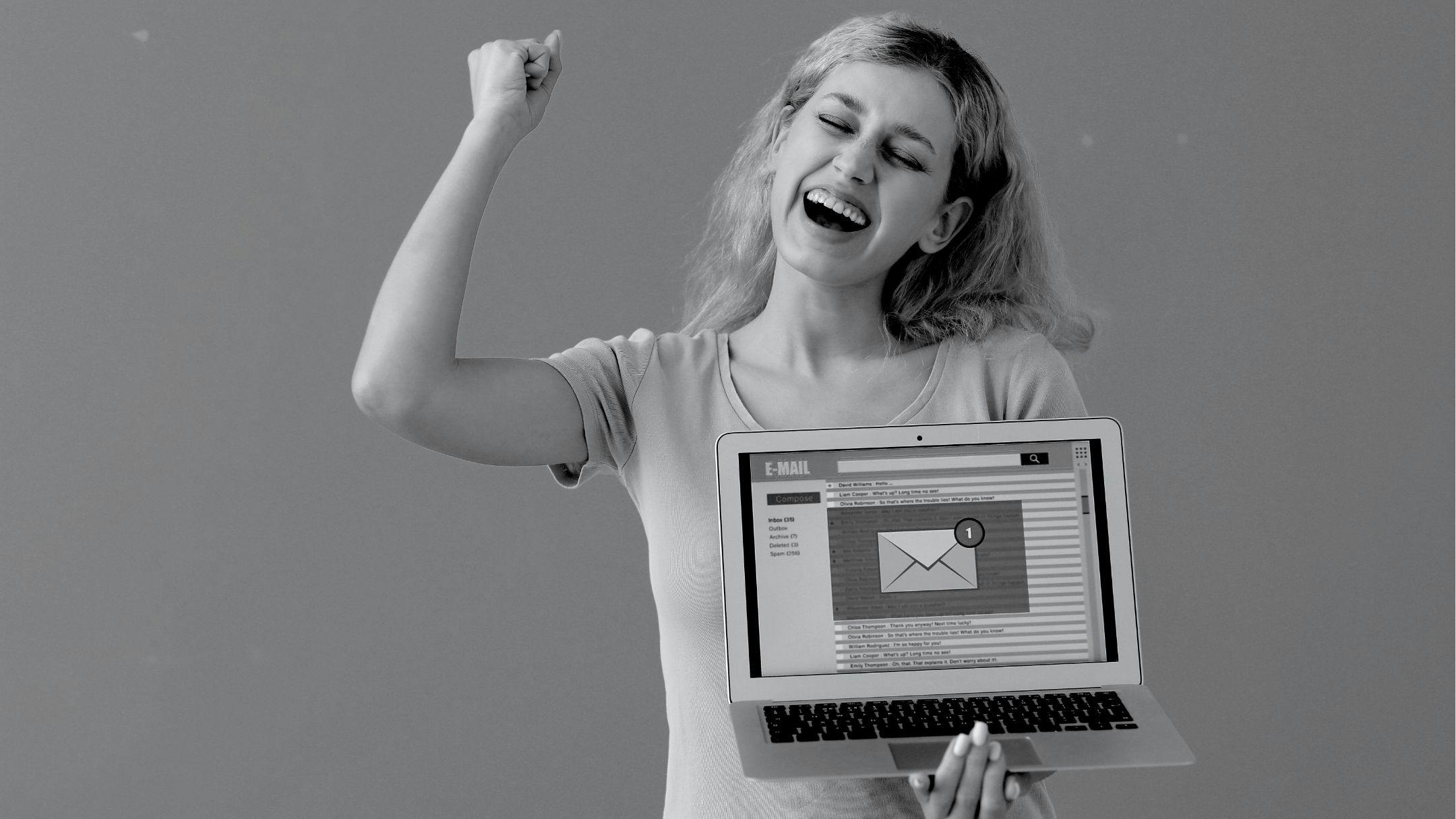 women holding a laptop containing image of email