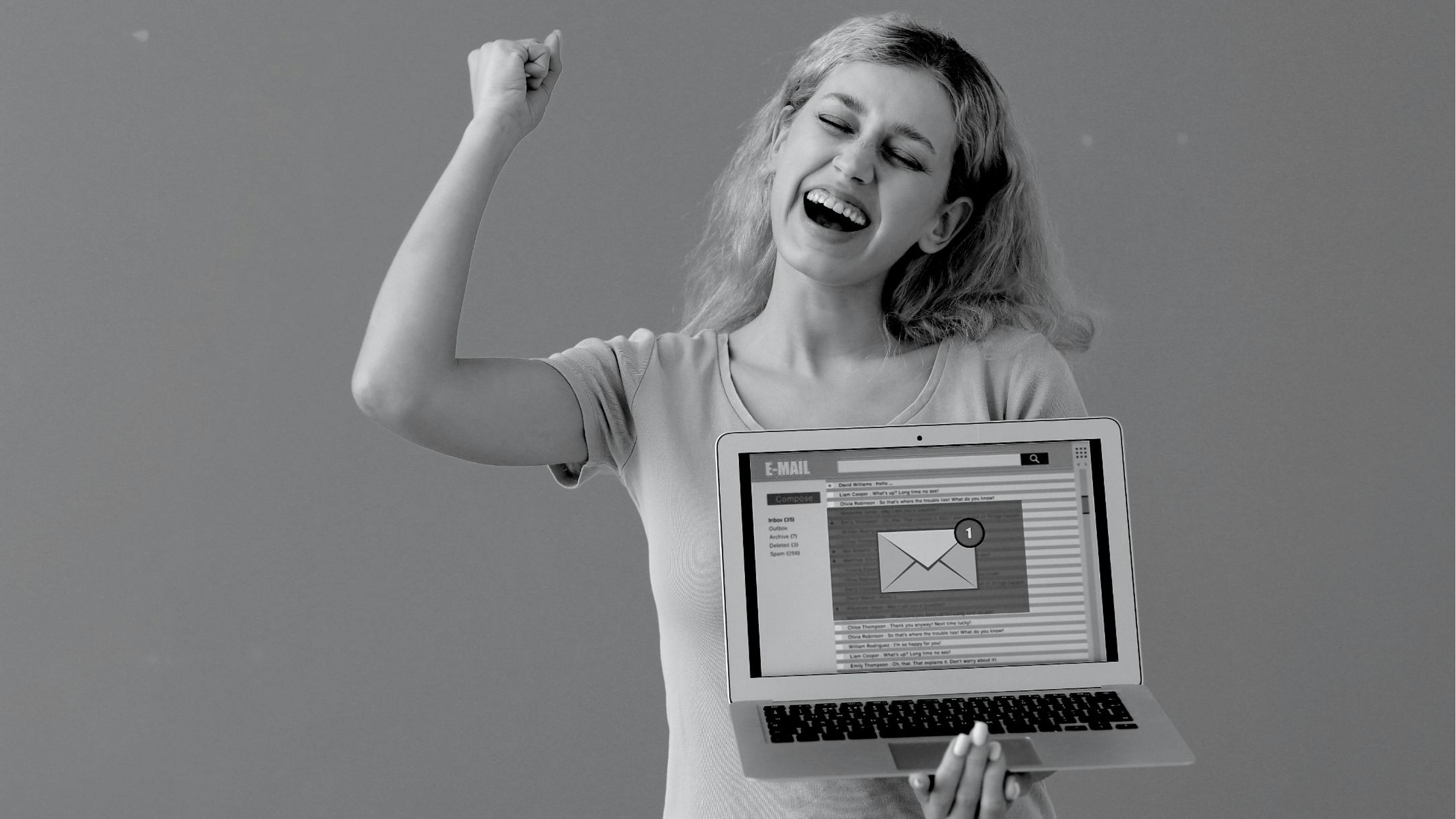 women holding a laptop containing image of email