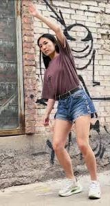 Asian woman pretends to be an NPC in a Tik Tok video.