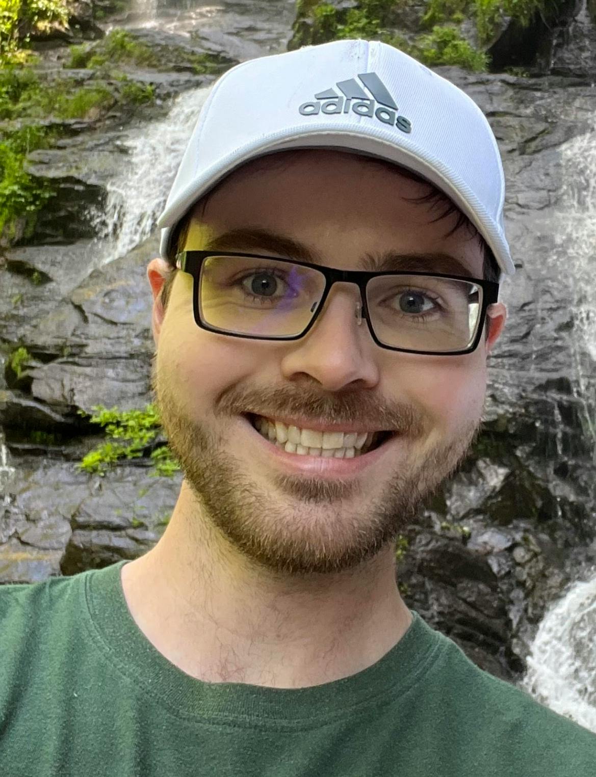 The man is looking into the camera and smiling