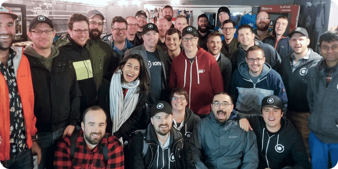 Ionic team members gathered in what looks like a shed somewhere cold