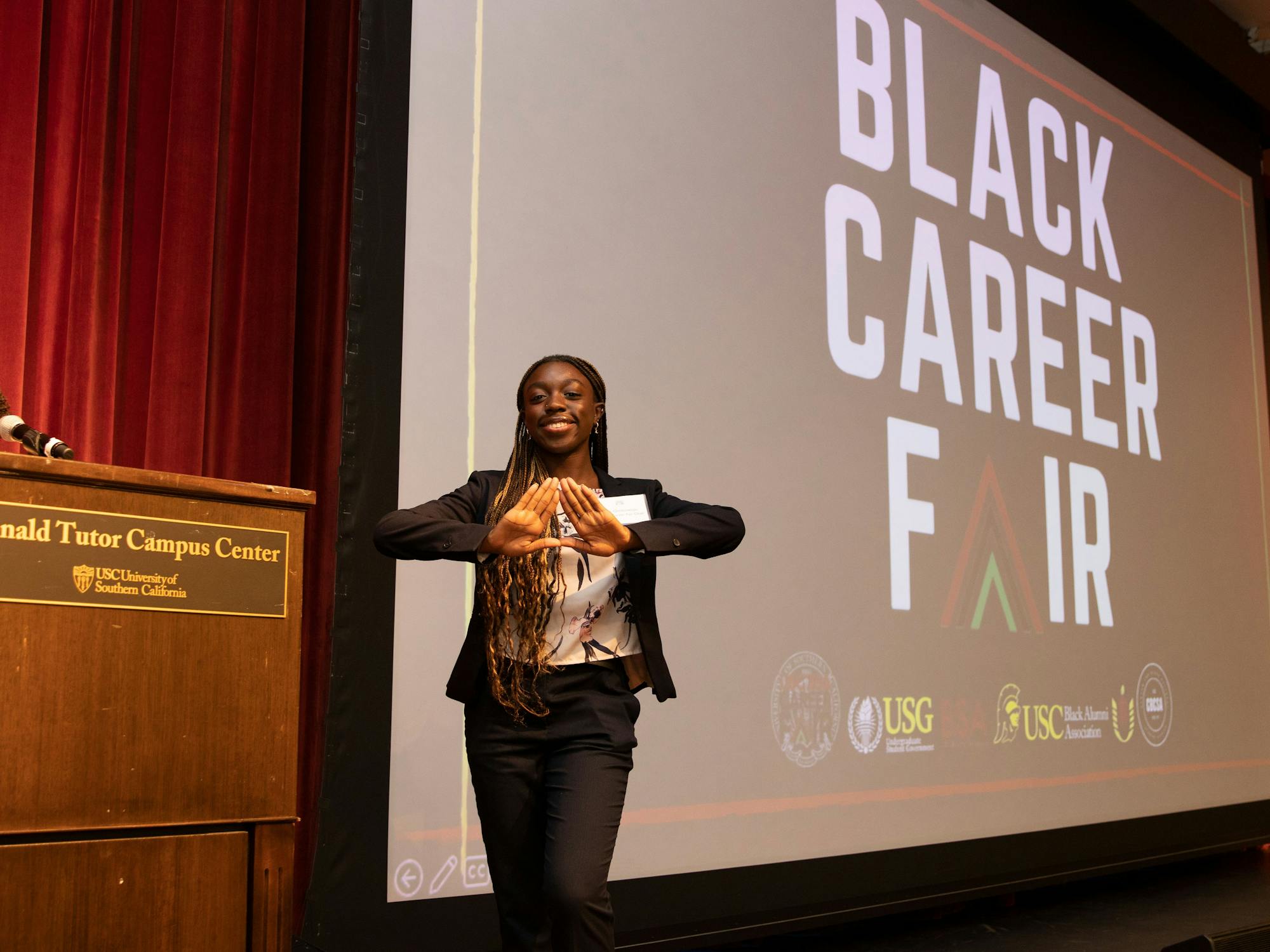 Person stands in front of screen that says Black Career Fair