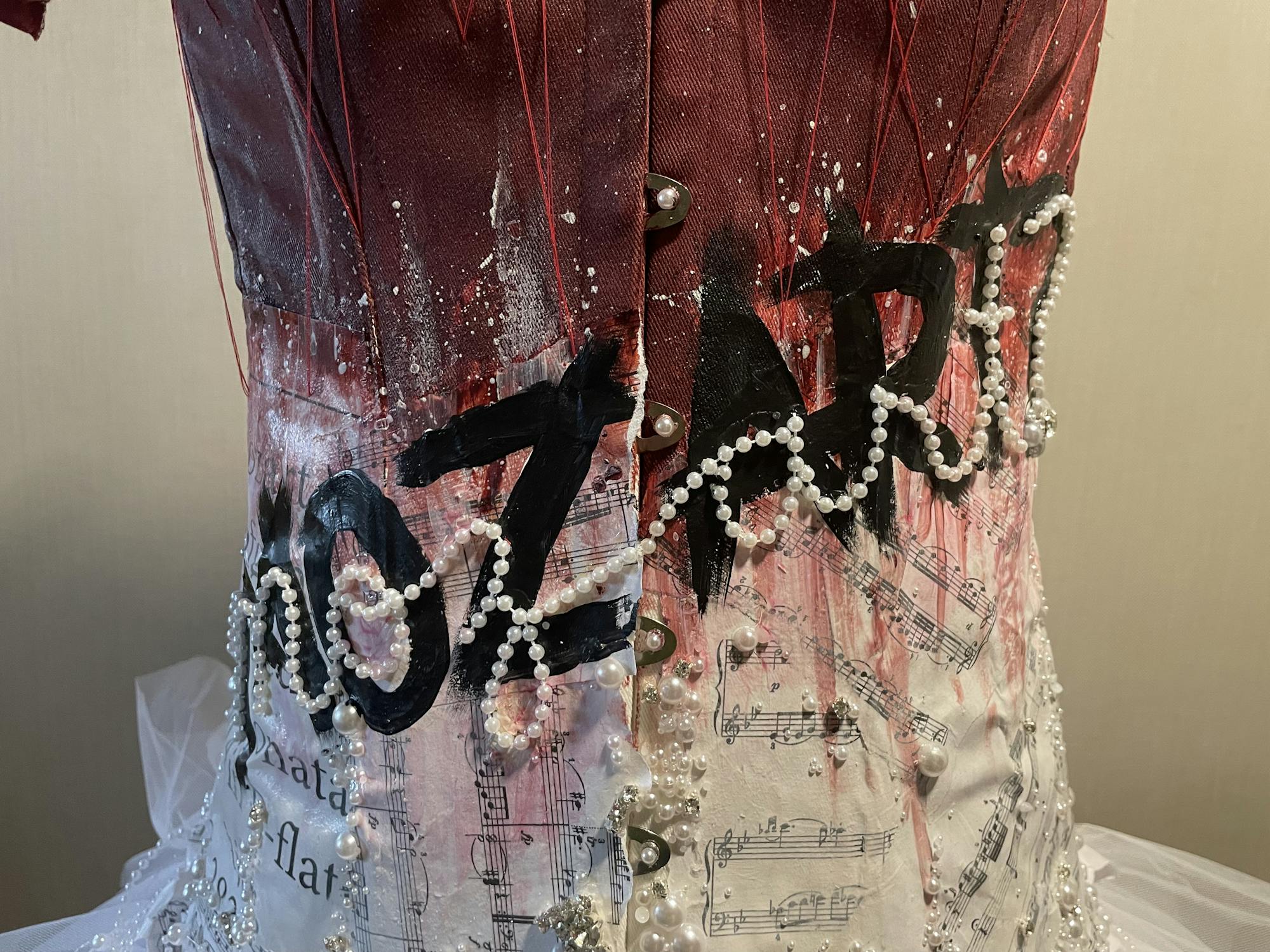 A red corset with the word Mozart 
