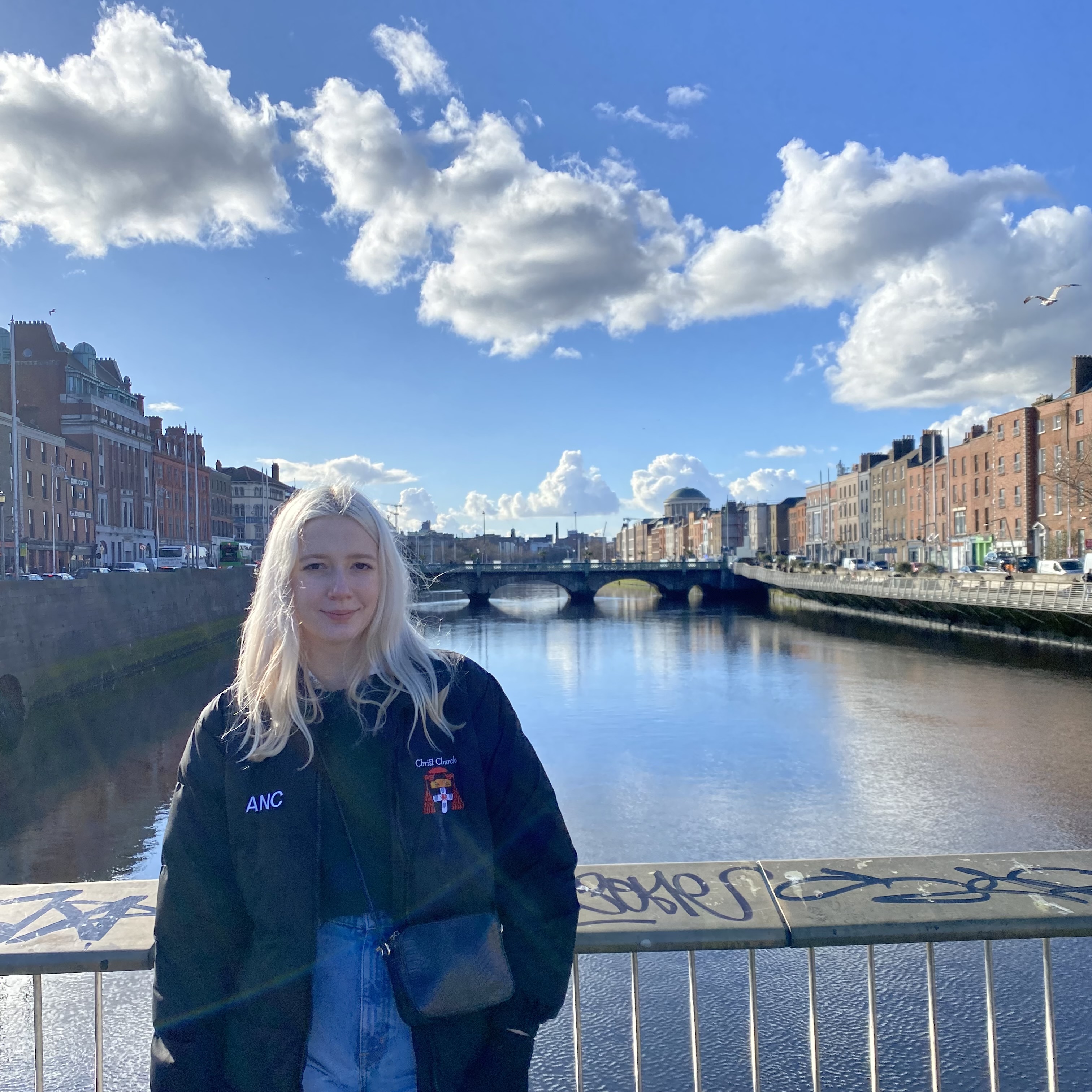 Amanda Curtis smiling, posing next to a river. 