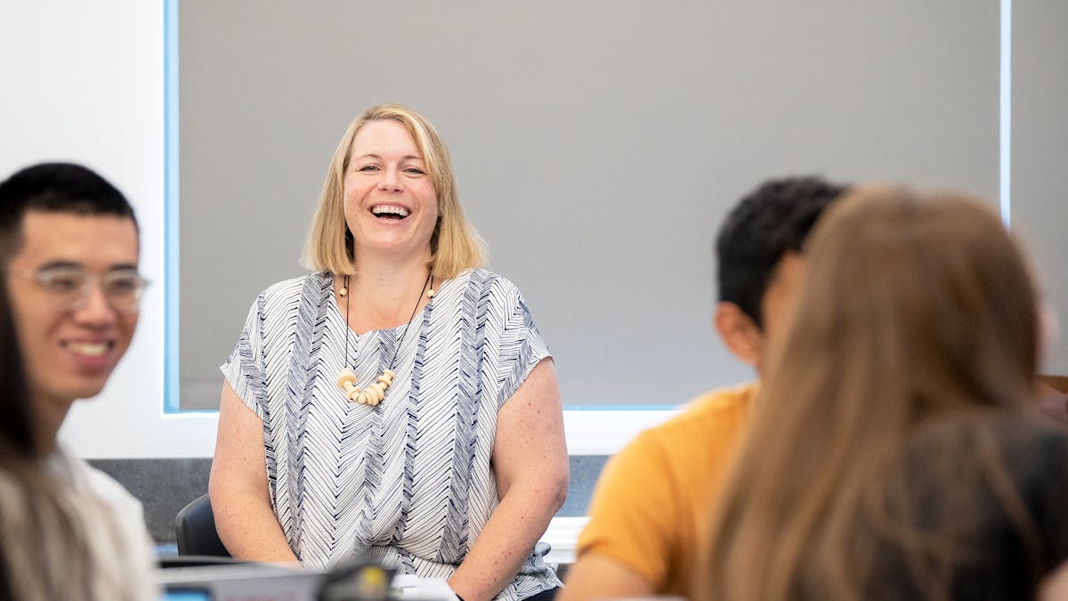 Female professor laughing with students