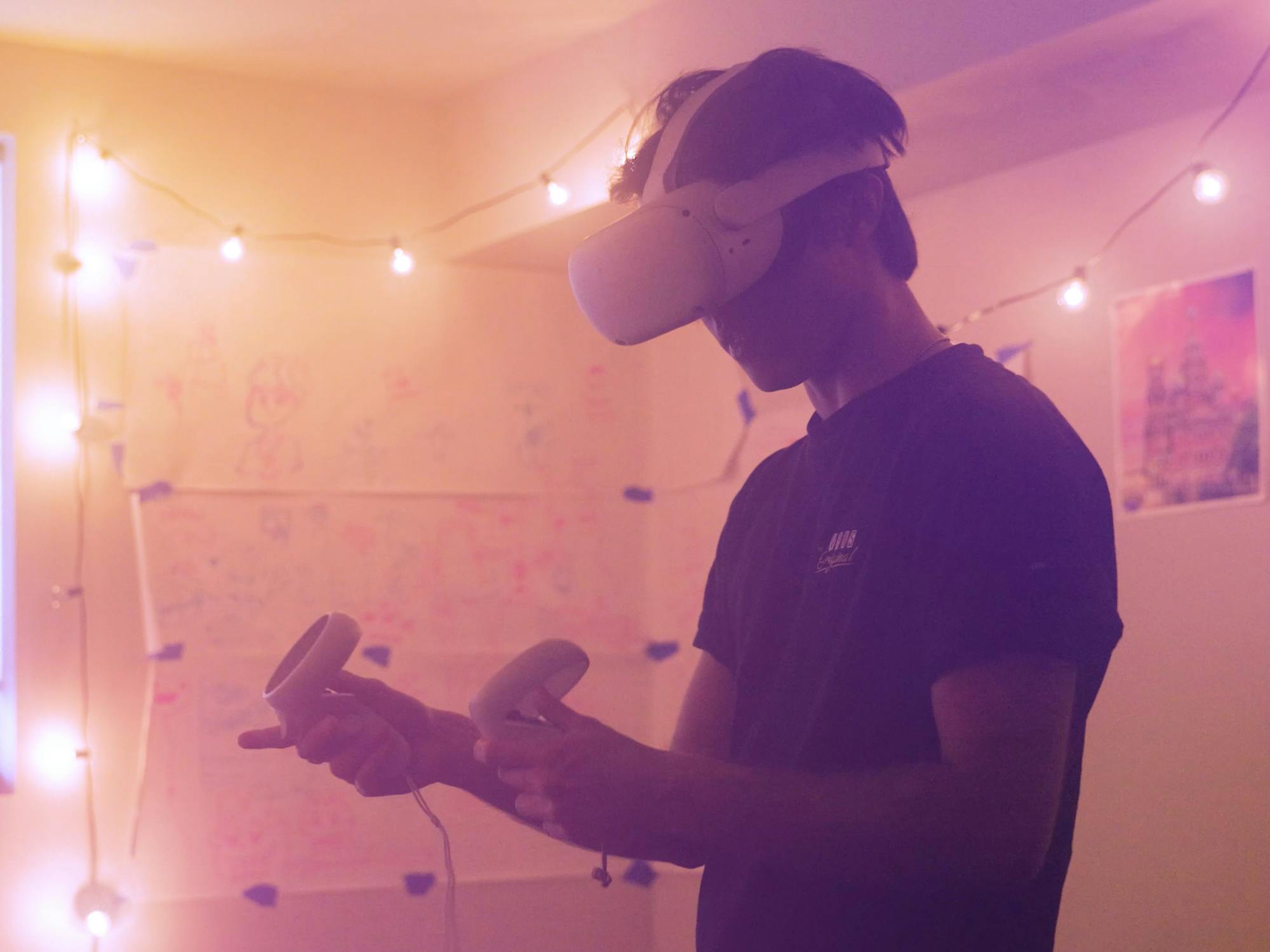 Male in VR headset in room with pink lights
