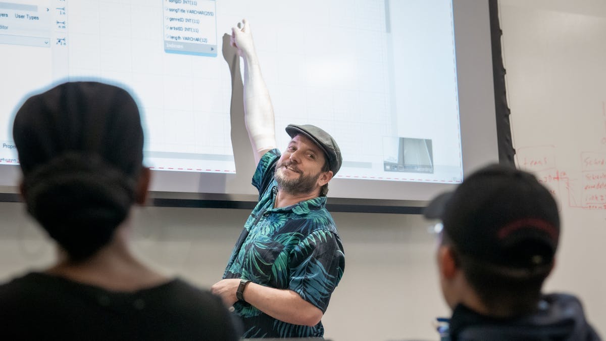 Professor pointing at projection screen