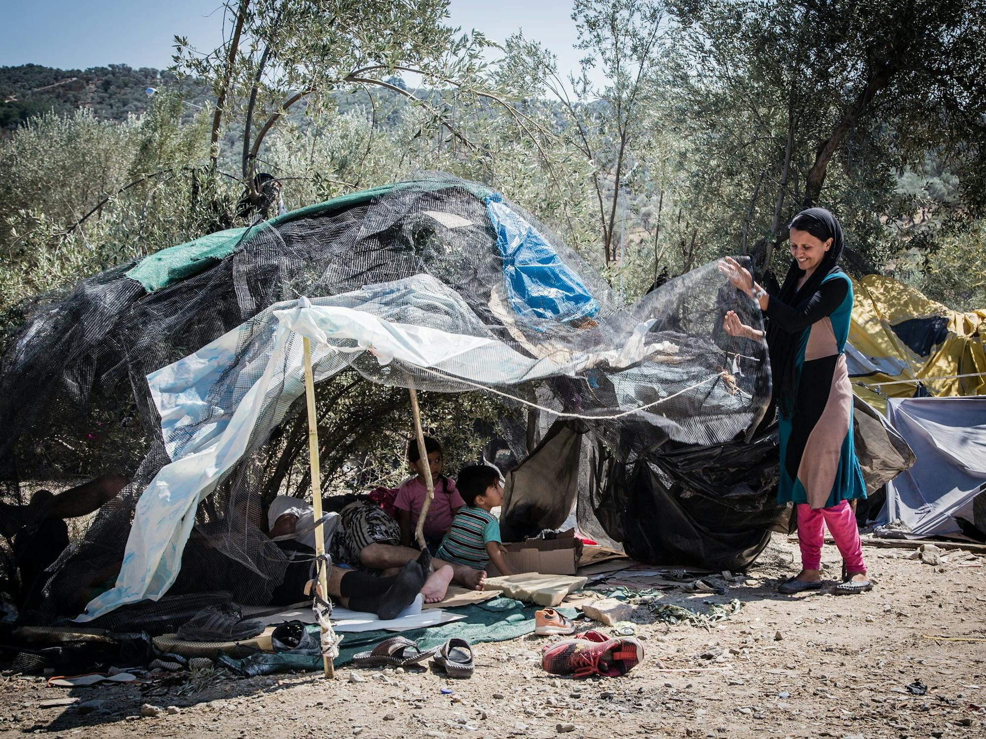 Woman standing by tent in Lesbos, Greece
