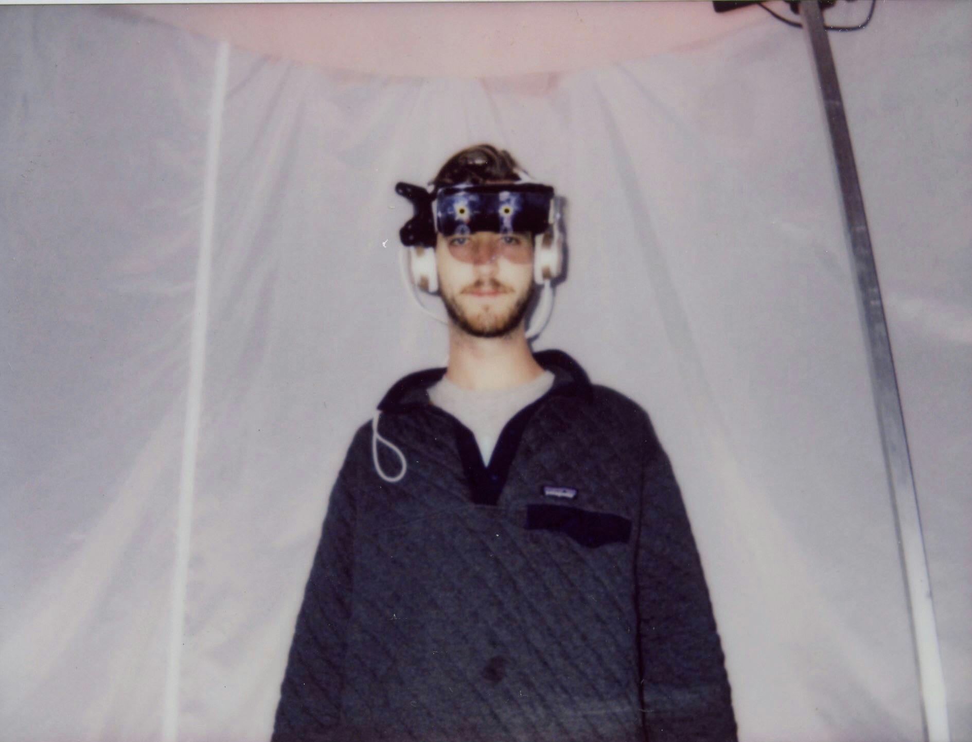 A young man in AR goggles and headphones