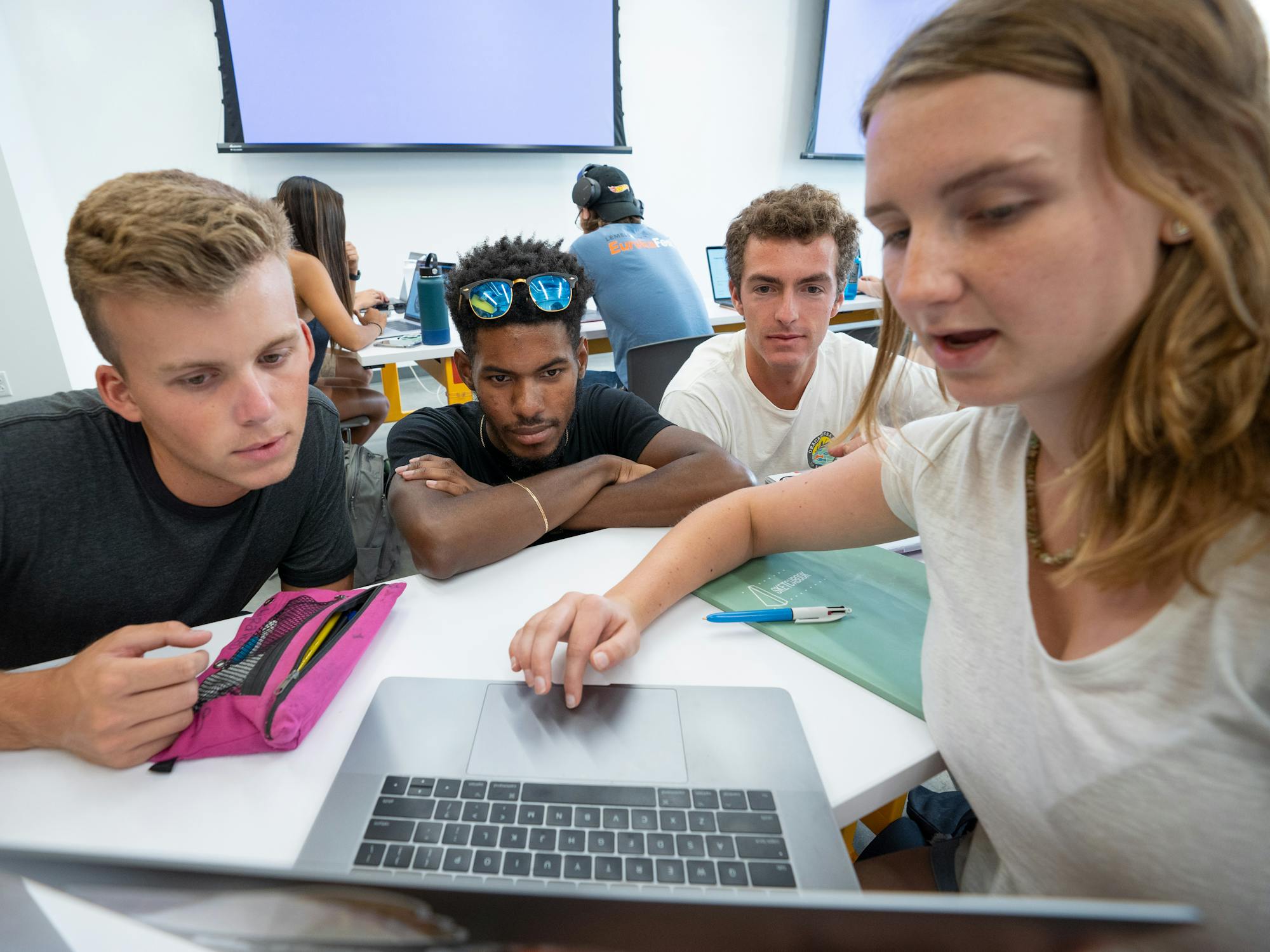 Group of students looking at laptop