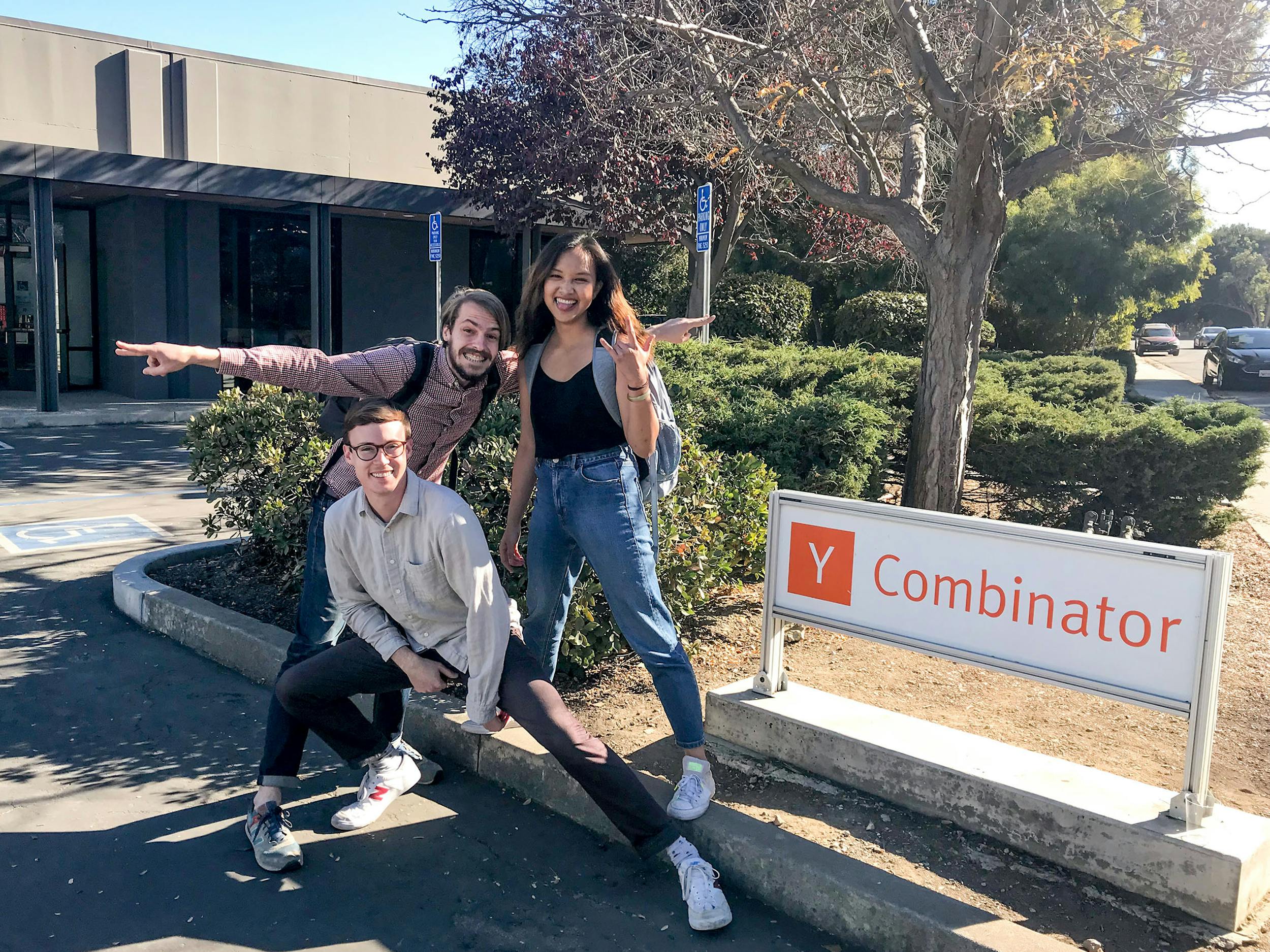 3 students pose by Y Combinator office sign