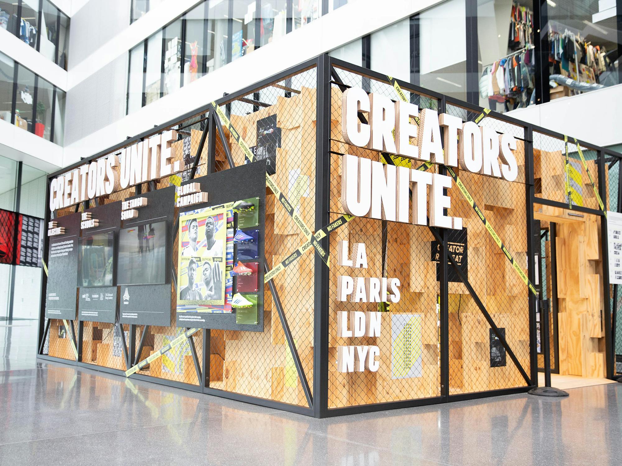 Indoor installation made of wood and steel with sign Creators Unite.
