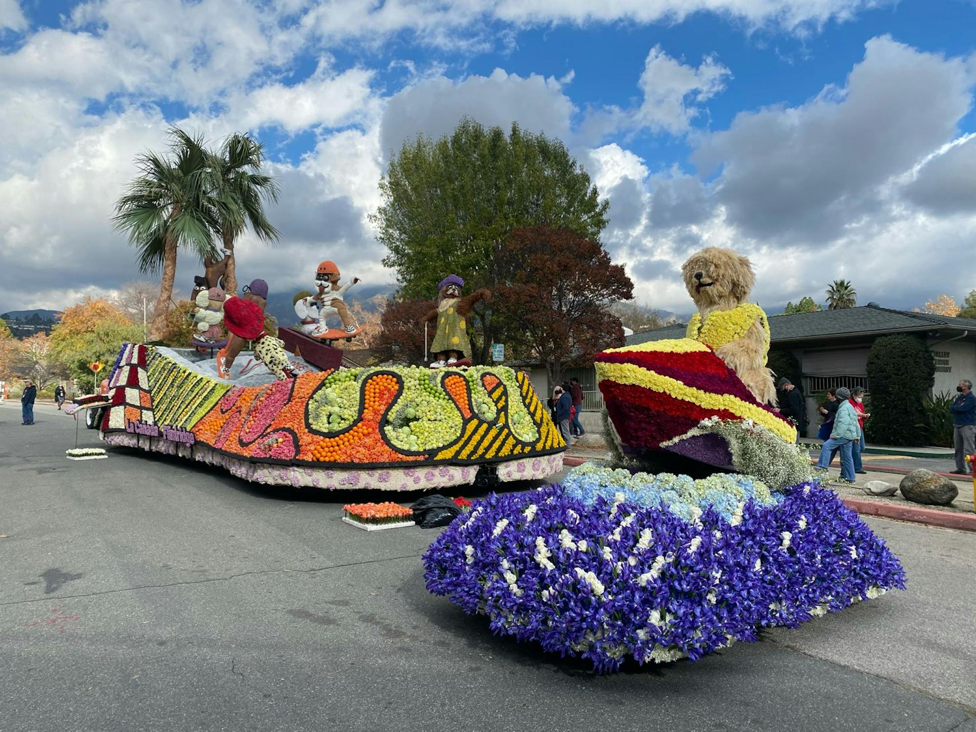 Parade float with orange, green, purple flowers