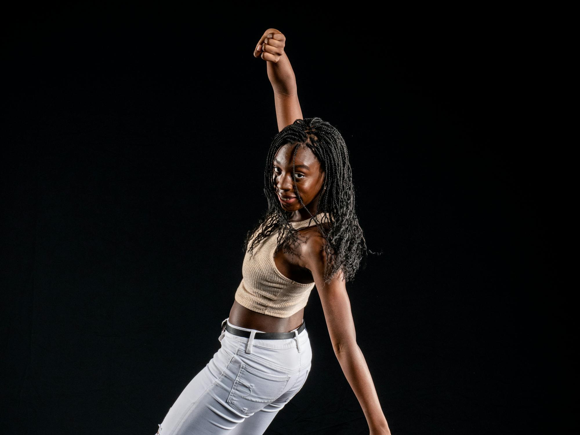 a woman dances in tap shoes and jeans strikes a dance pose 