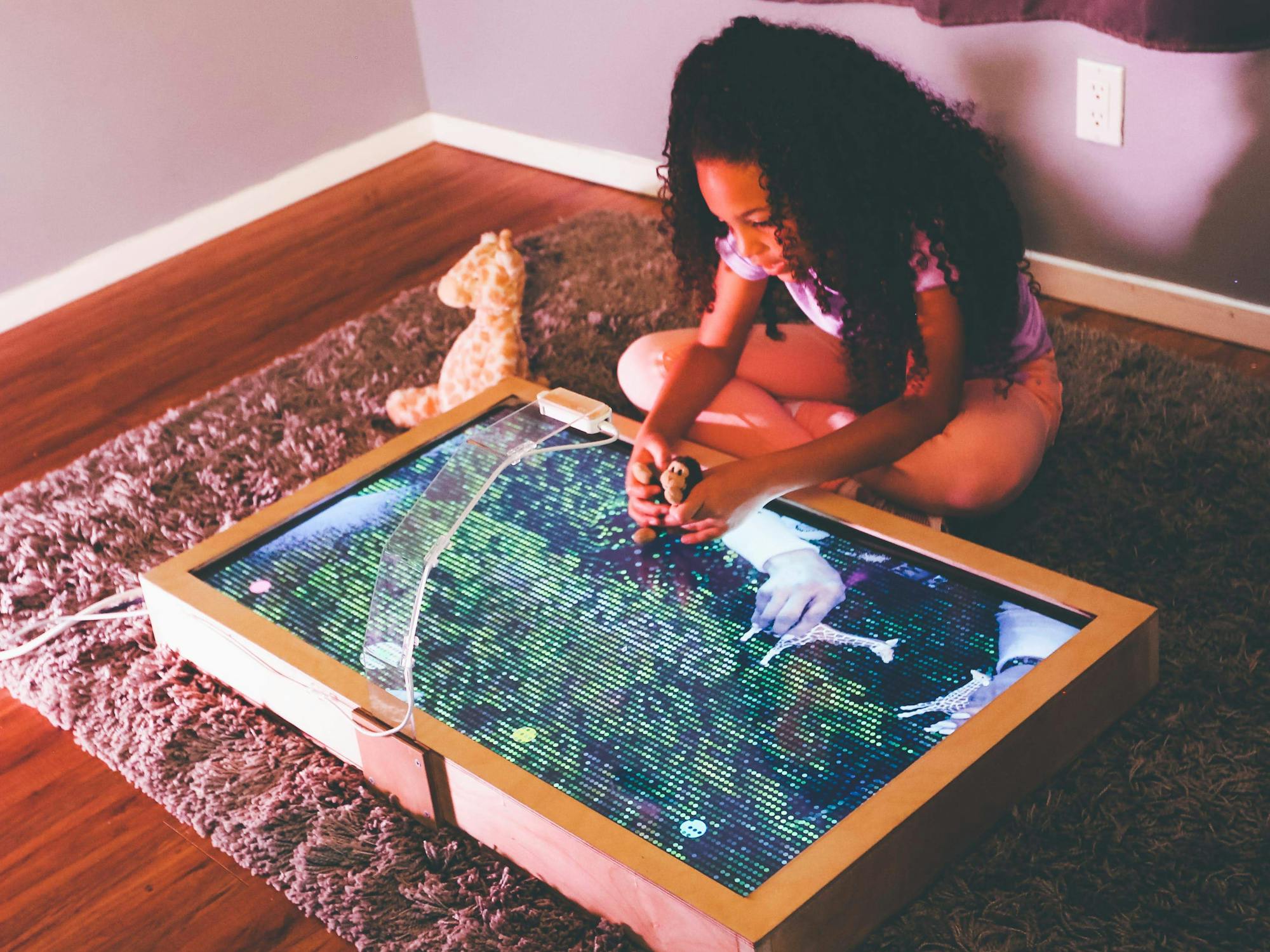 Young girl looking at table with digital display