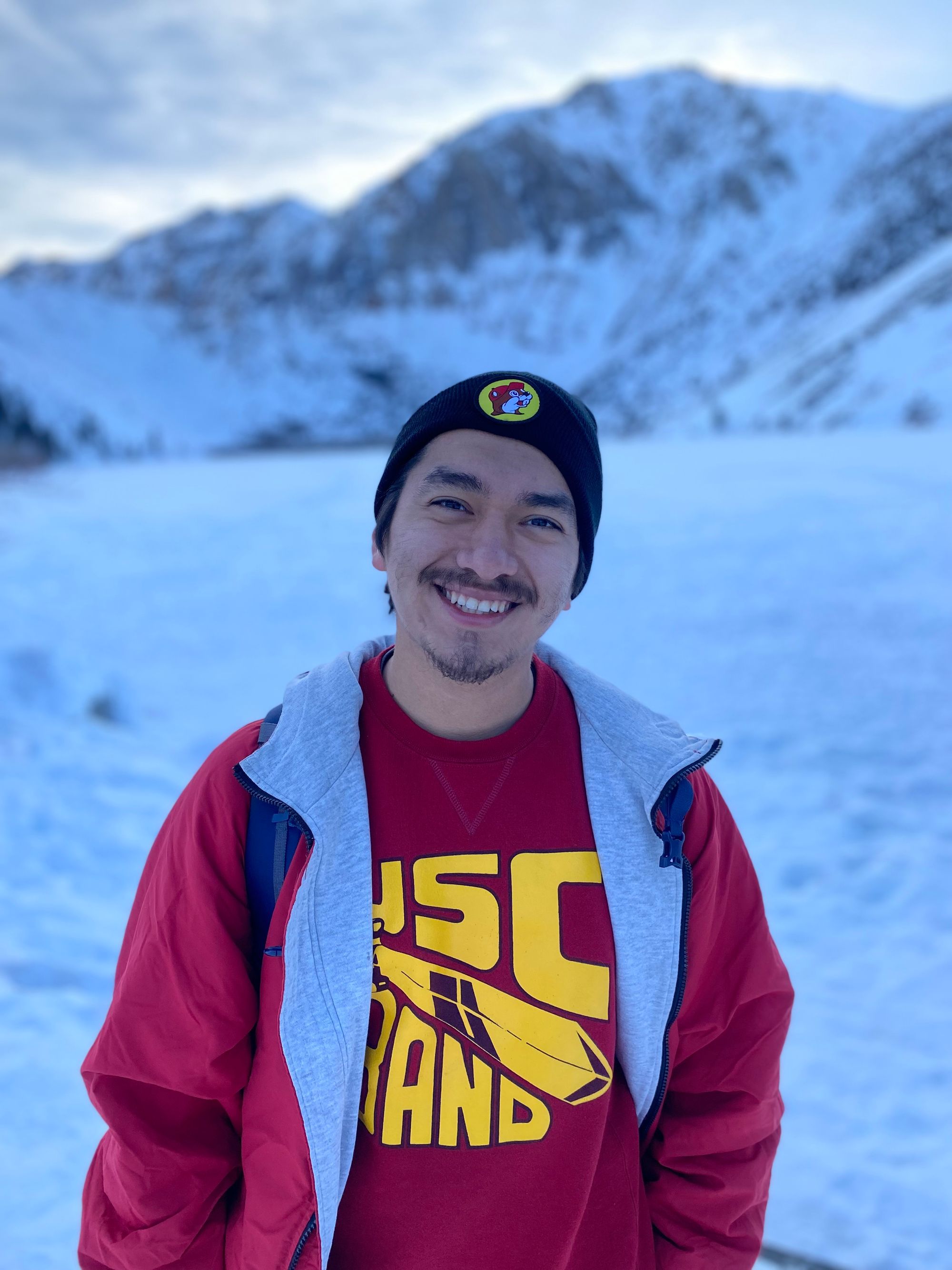 man posing in snow with usc sweatshirt 
