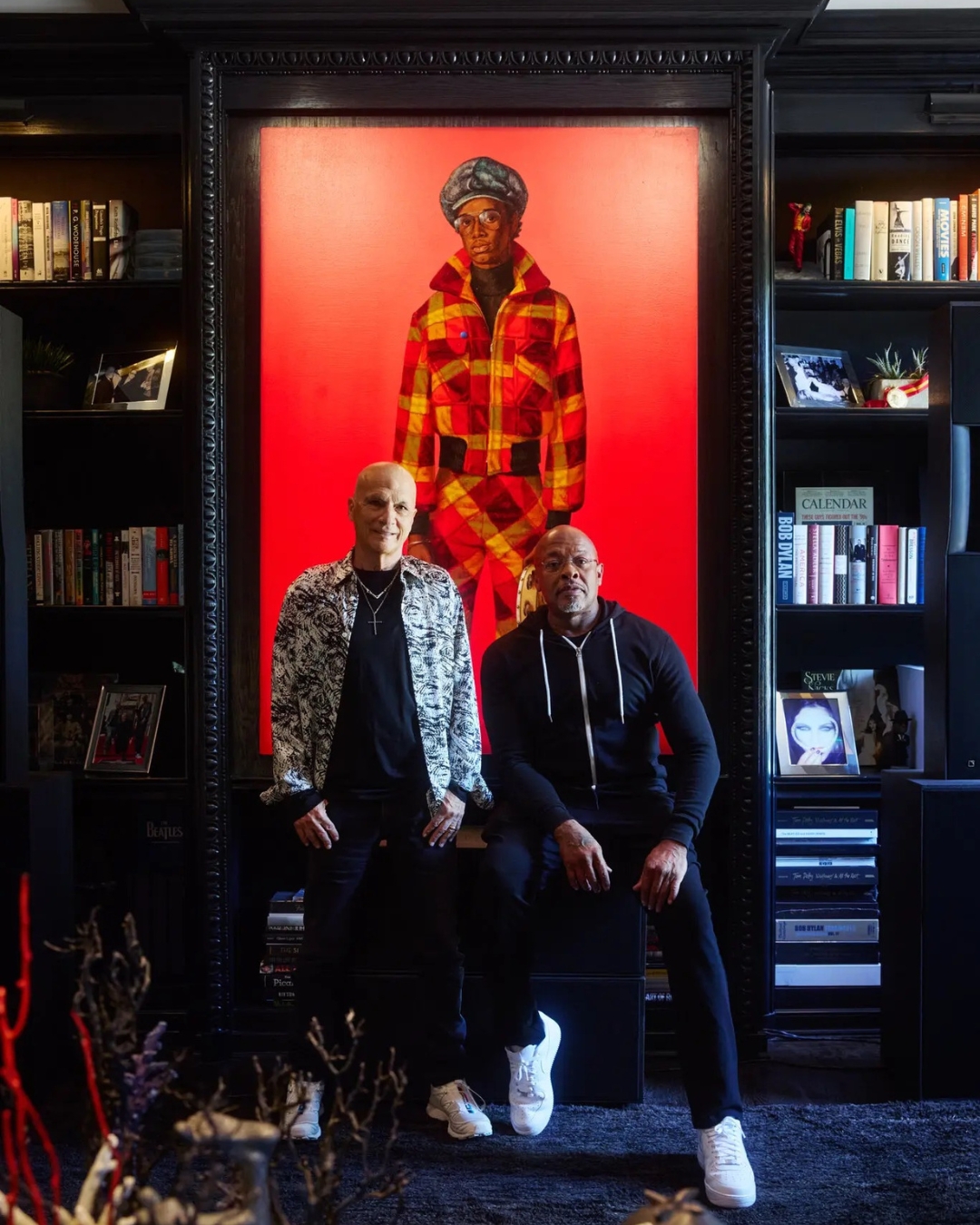 Jimmy Iovine and Andre "Dr. Dre" Young sit in a small library. 