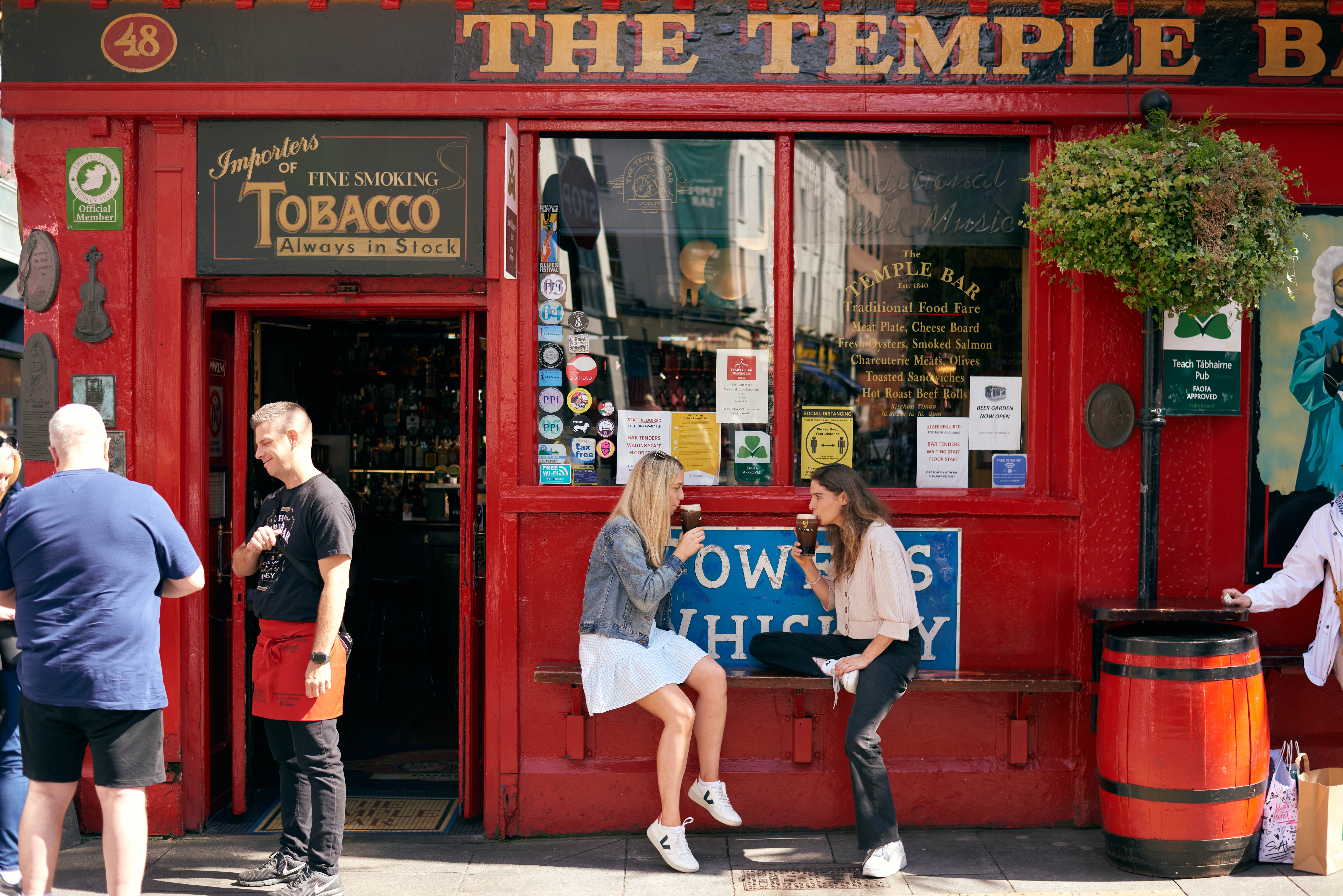 Travelers enjoying the Temple Bar Pub as a part of their Multi-Day Ireland Tour experience itinerary created by Ireland Whiskey Tours
