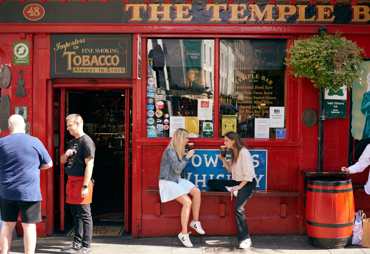 Travelers enjoying the Temple Bar Pub as a part of their Multi-Day Ireland Tour experience itinerary created by Ireland Whiskey Tours