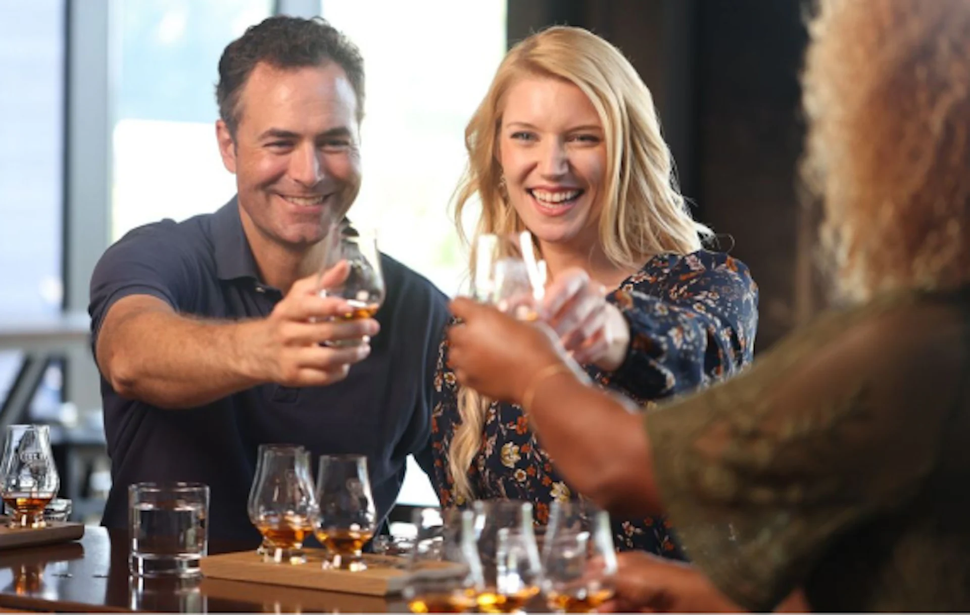 Guests toasting on a whiskey tour
