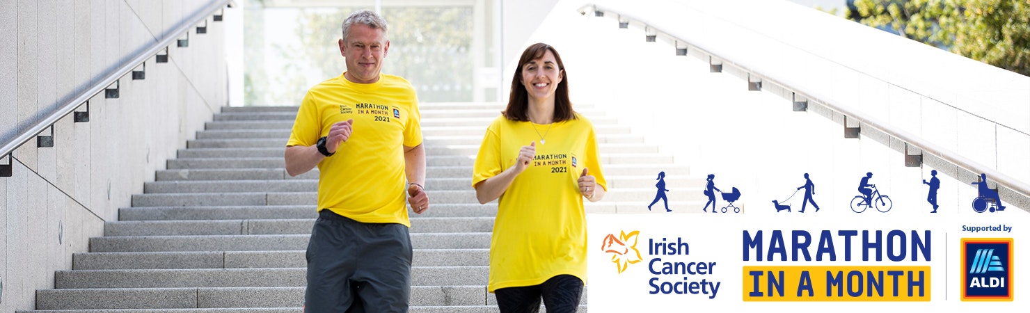 Irish Cancer Society Marathon in a Month - two people walking down stairs in yellow tops