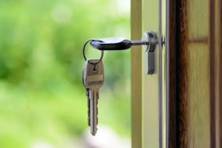 An image of a key in a door