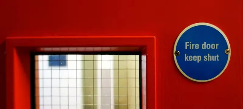An image of a red fire door