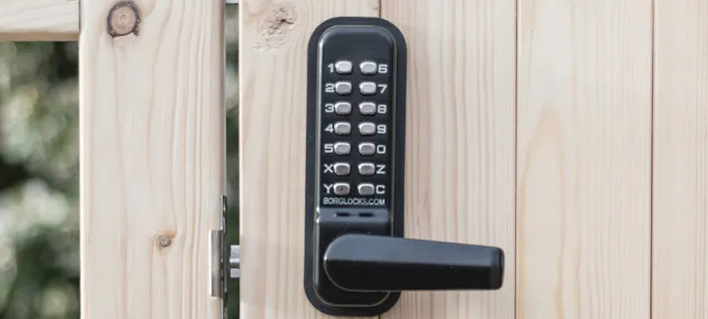 An image of a black door lock on a wooden door
