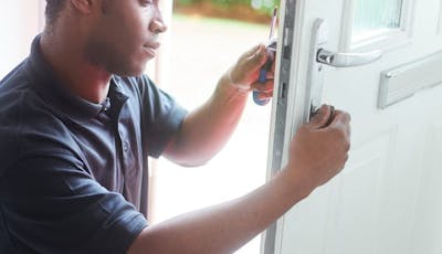 An image of maintenance on a uPVC door lock
