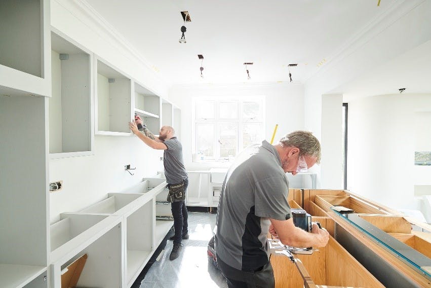 Tradesmen replacing a kitchen