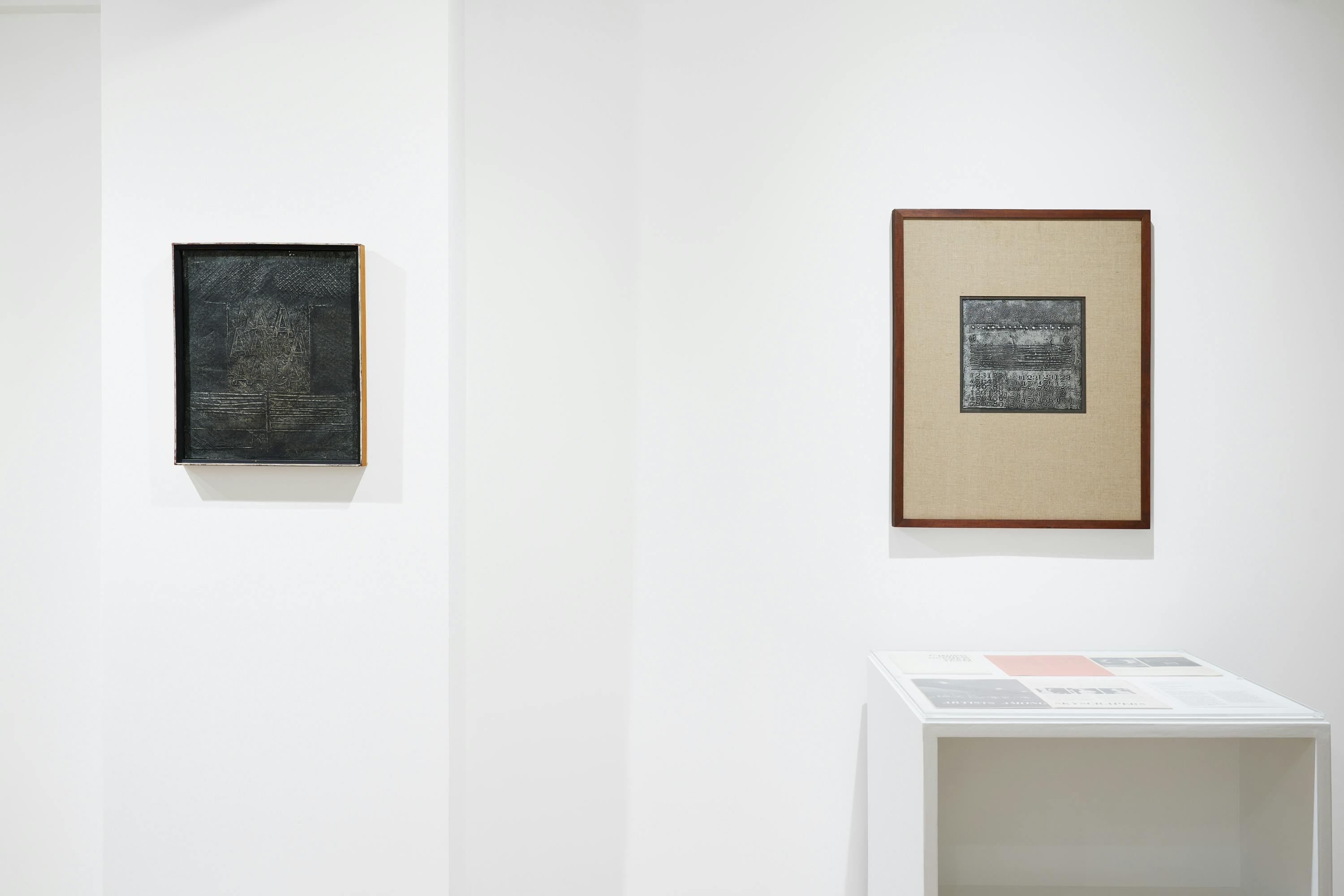 Installation view of two aluminum foil paintings by José Antonio Fernández-Muro and one vitrine.