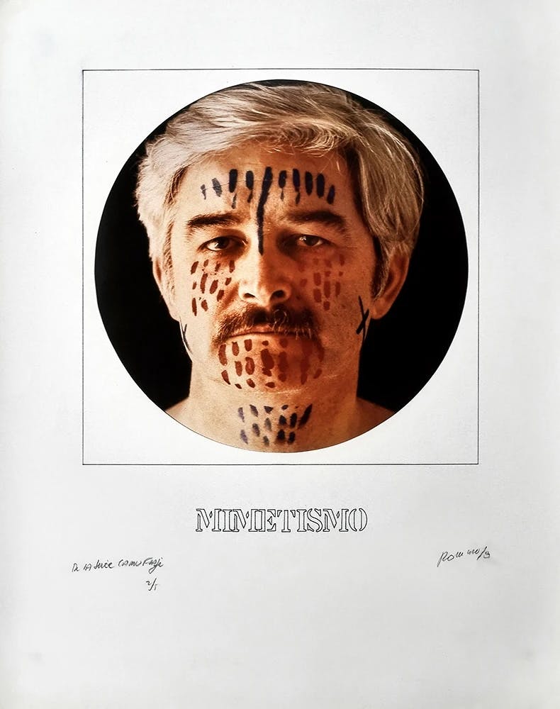 A series of four works on paper is laid out here in a grid. In the lower left corner, a head-on photograph of the artist, Juan Carlos Romero, shows his face covered in short vertical lines of blue and red paint; the caption reads “MIMETISMO.”