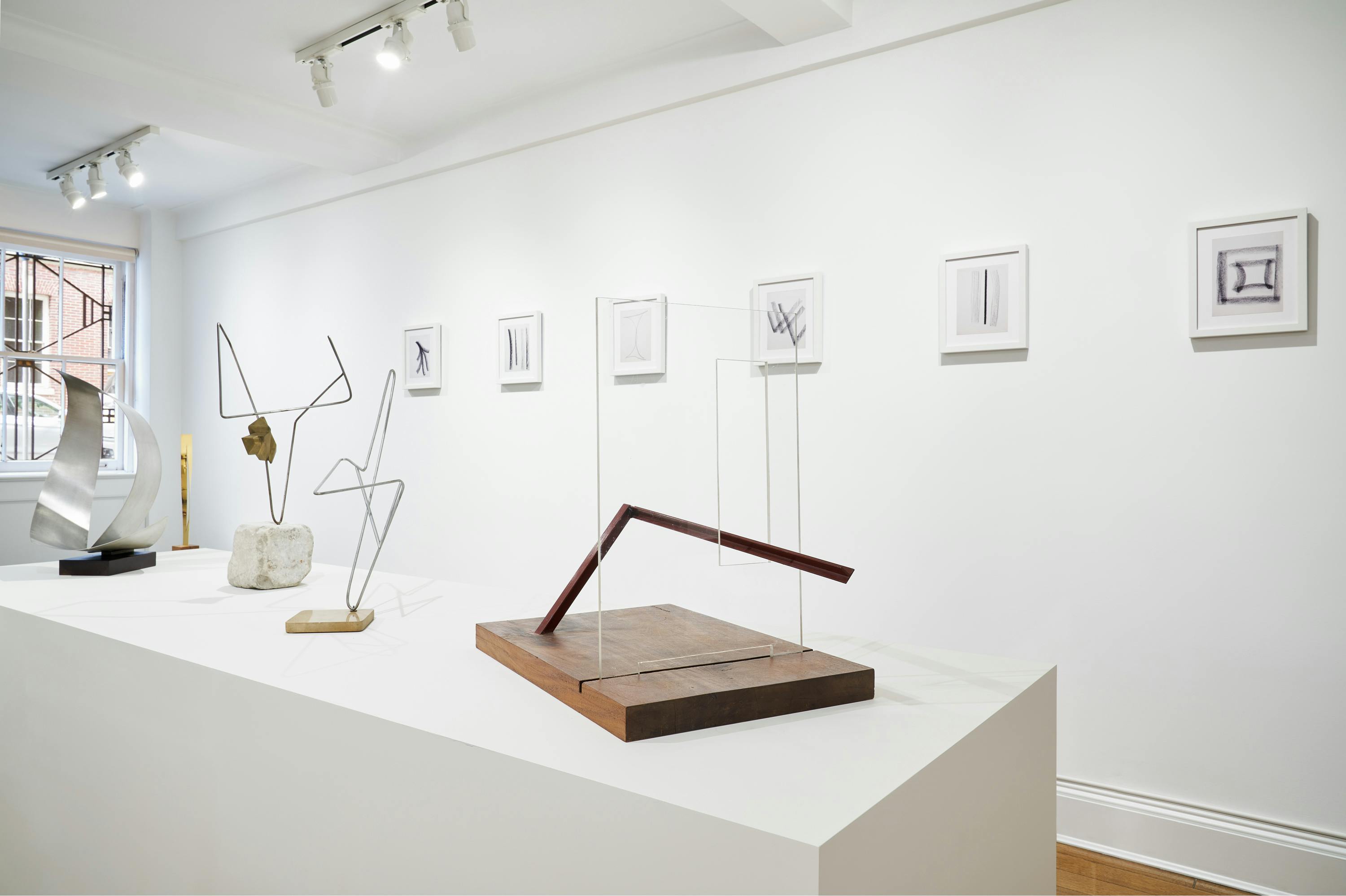 Gallery view of From Surface to Space exhibition showing five free-standing sculptures and six wall-mounted drawings.