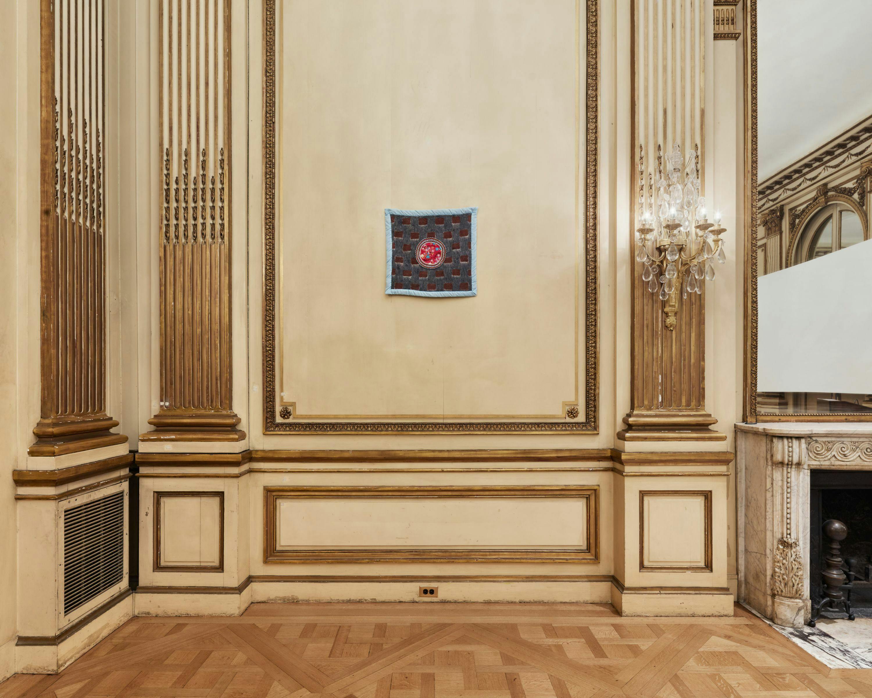 Installation view of the exhibition with artwork on the wall framed by wall moldings