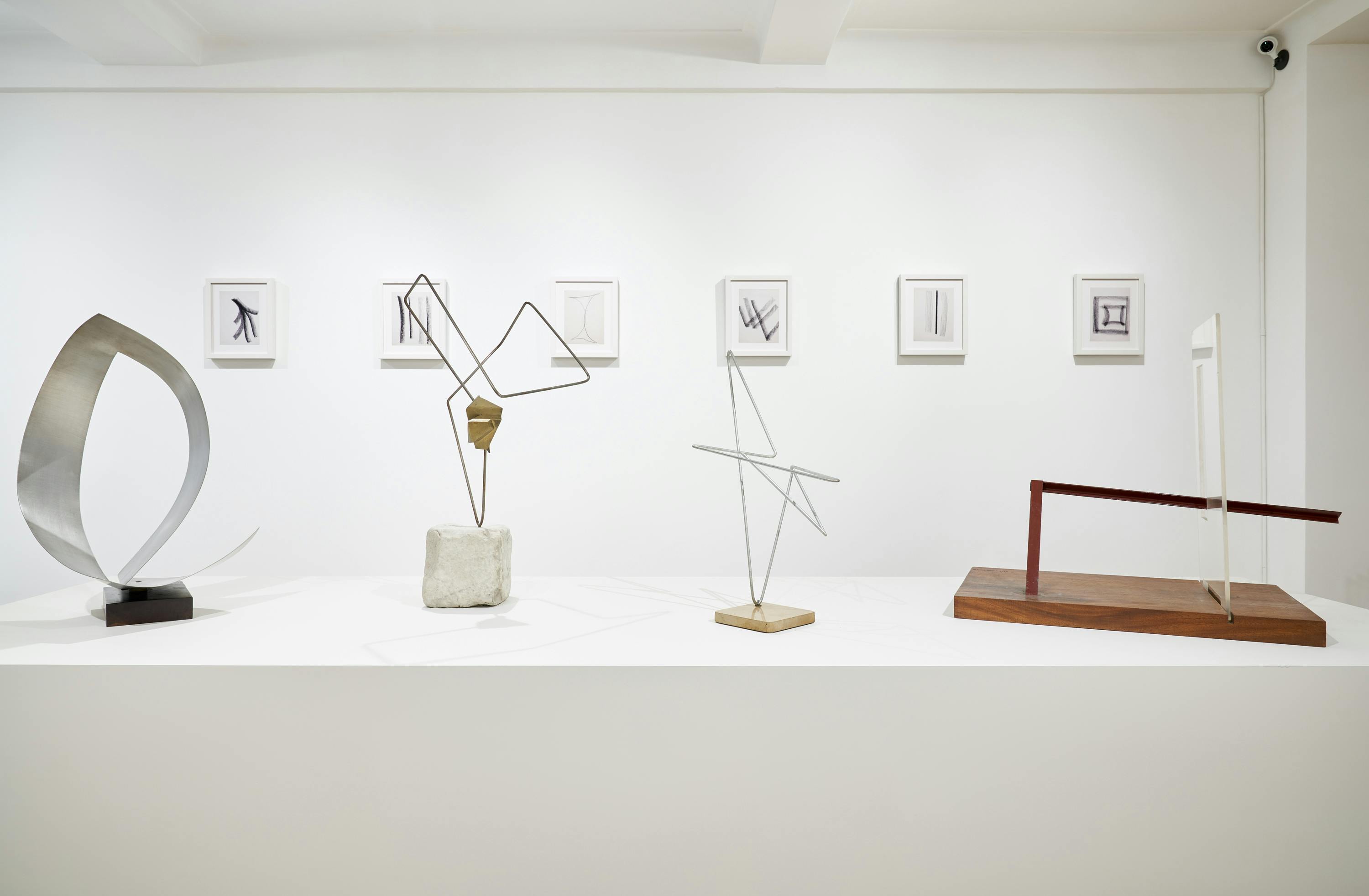 Gallery view of From Surface to Space exhibition showing four free-standing sculptures, and six wall-mounted drawings.