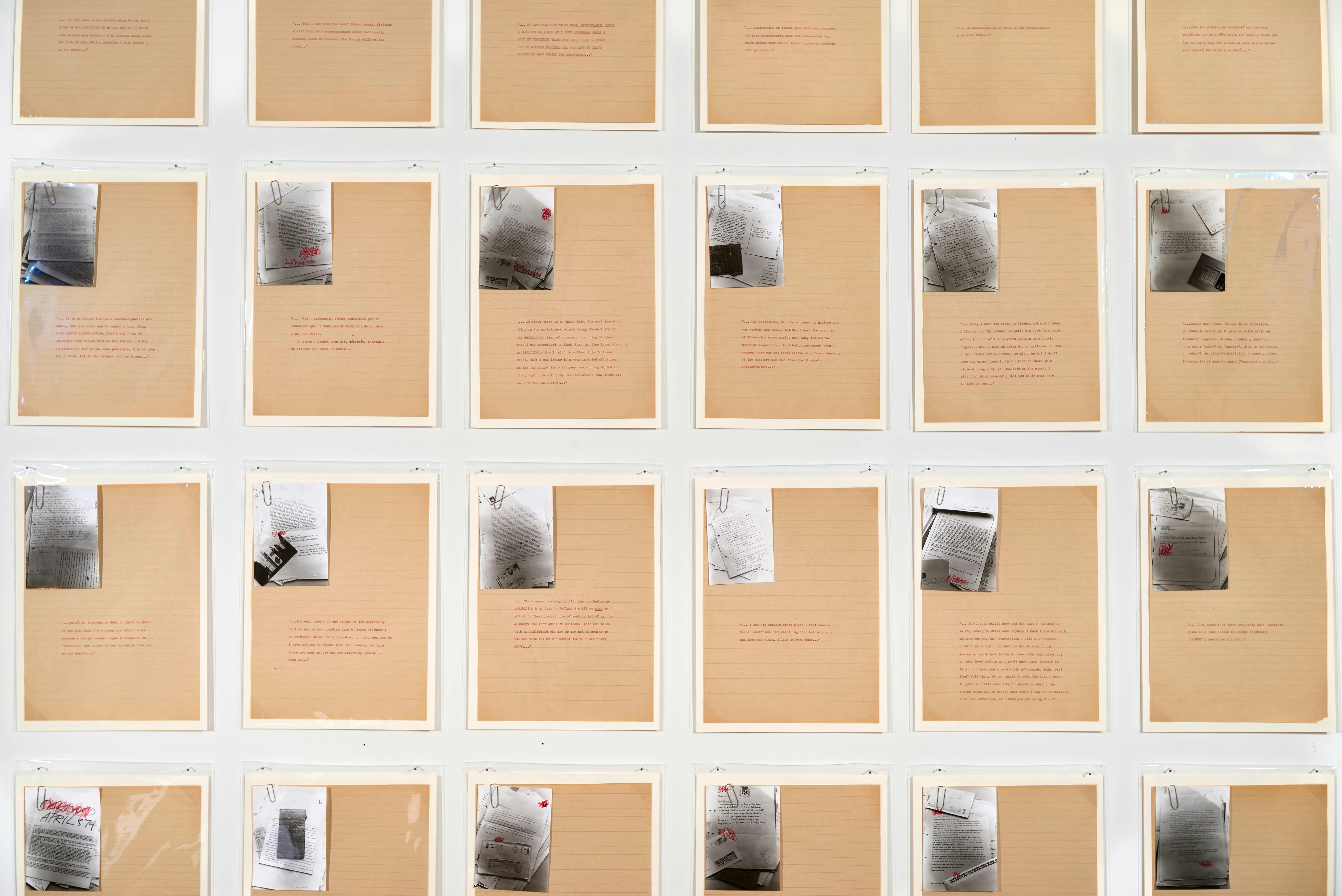 A grid of tan notebook paper with black and white photographs attached to each page with a paper clip.