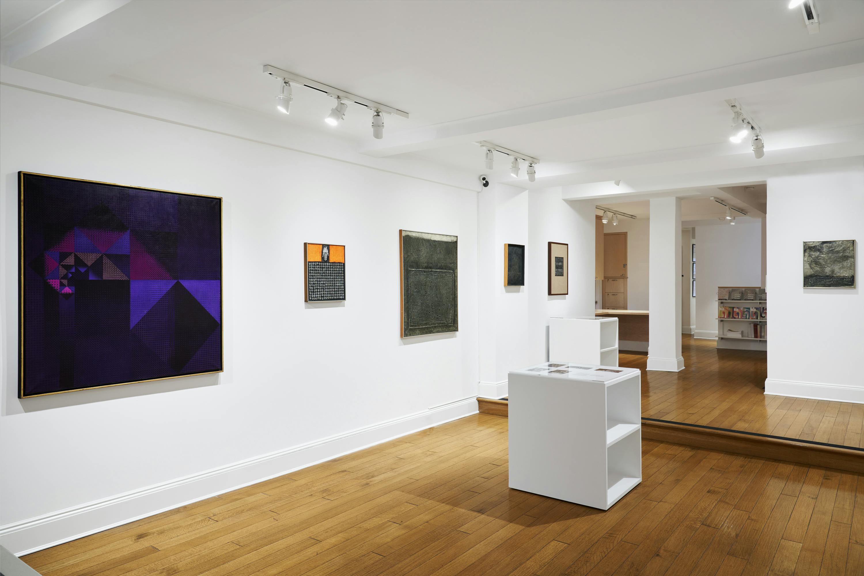 Installation view of José Antonio Fernández-Muro: Geometry in Transfer exhibition showing five paintings and two vitrines.