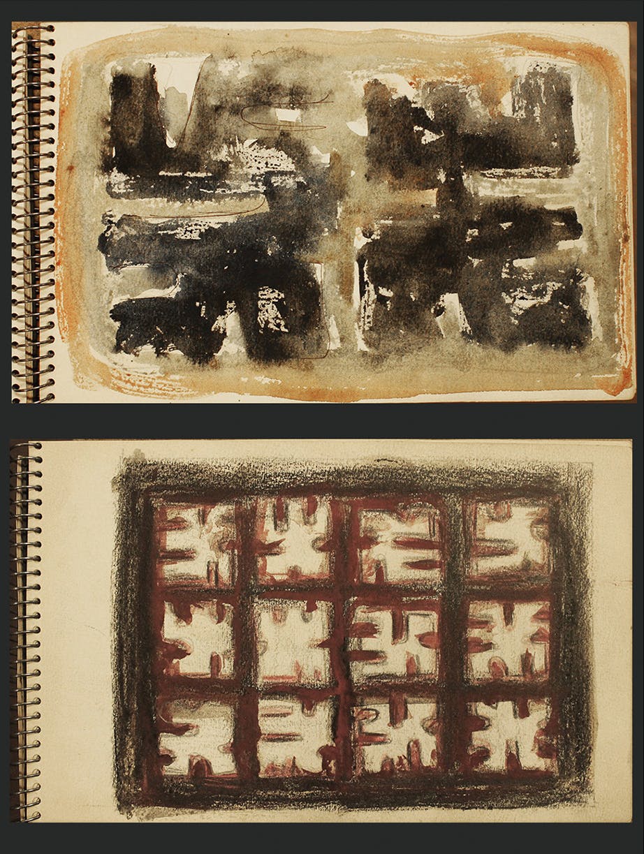 A sketchbook with a watercolor painting of two black abstract shapes.